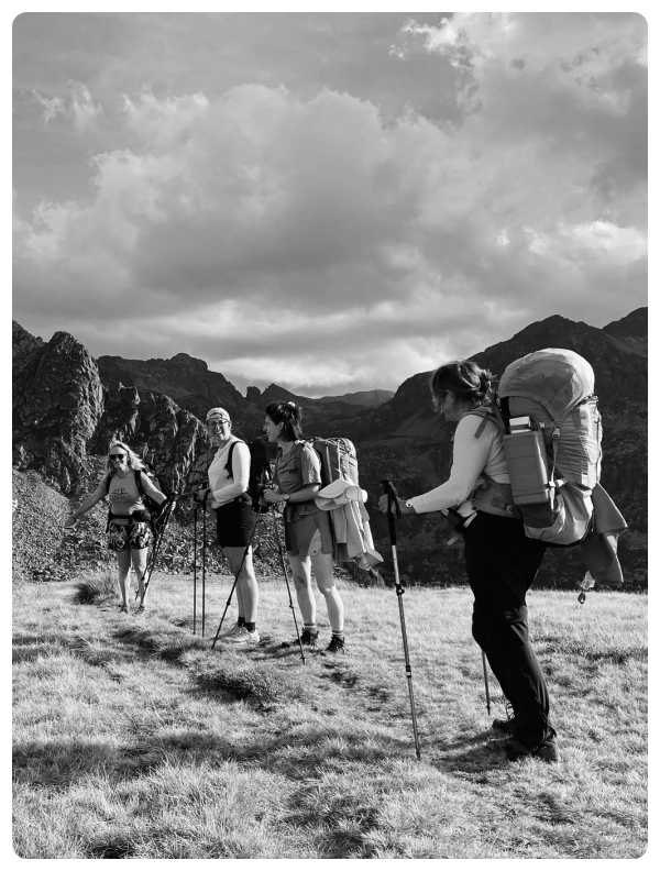 Black and white natural portrait of a group of women hiking with Anne Arran in the mountains during a vision quest adventure